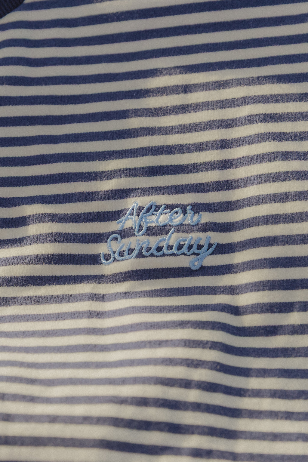 Close up of navy and white striped tee with After Sunday embroidery

