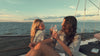 Women on a sailboat enjoying their time chasing the sunset, drinking rootbeer, and wearing Christian timeless apparel.